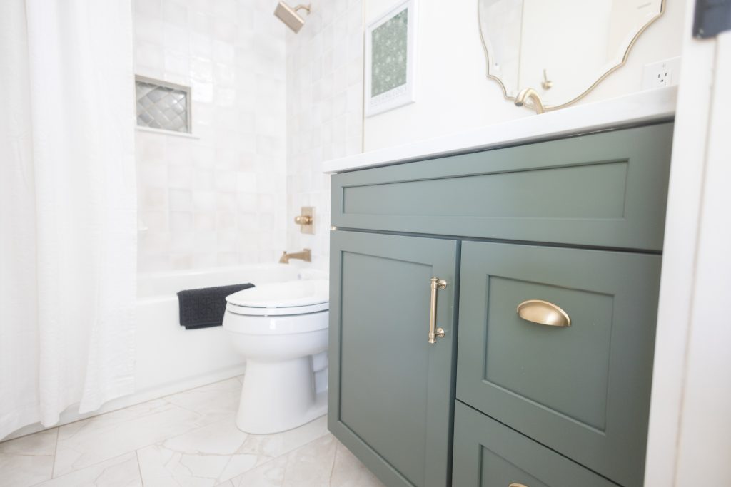 Bathroom with sage green vanity